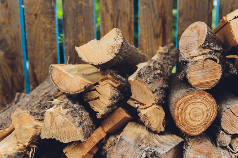 Stacks of firewood in the sawmill. Pile of firewood. Firewood background